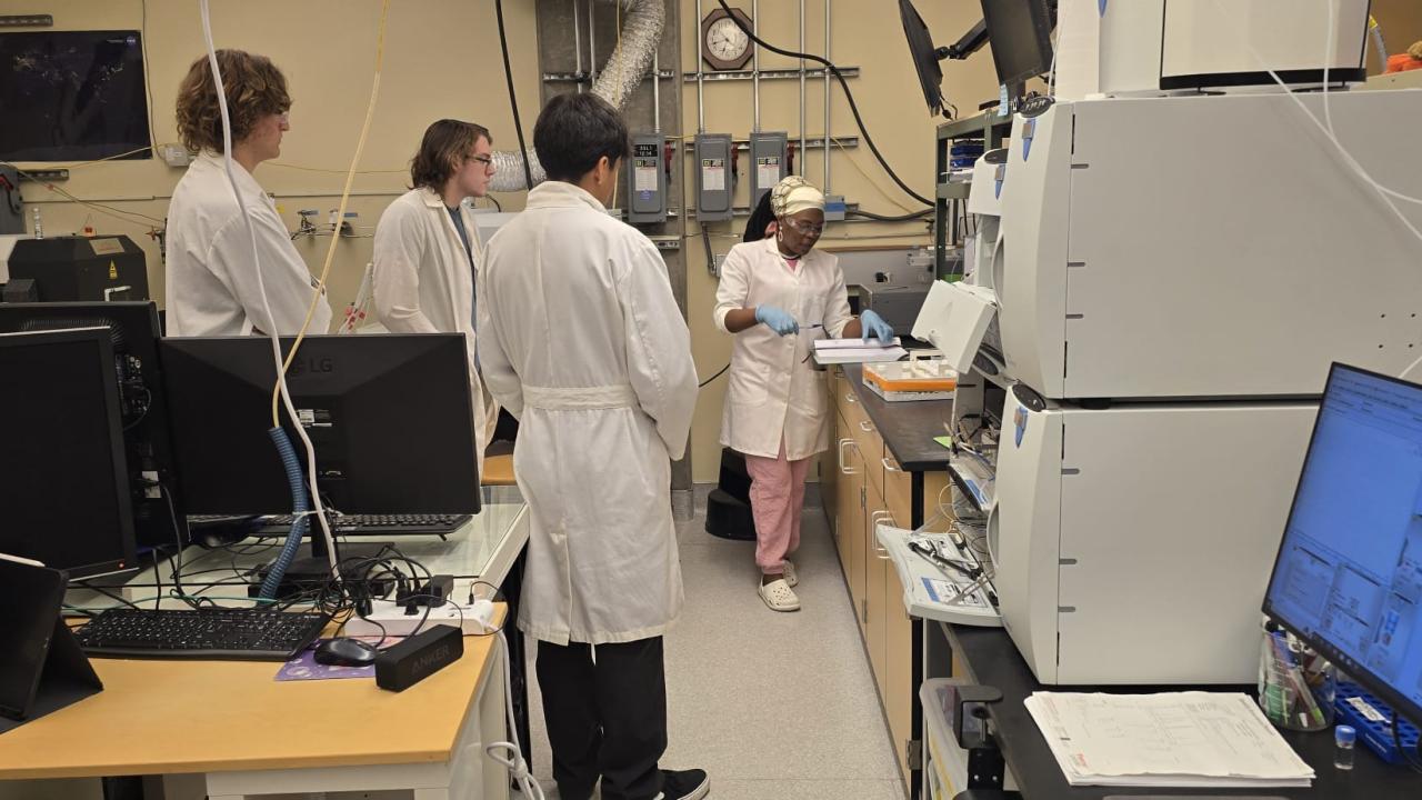 Claris in a lab with colleagues