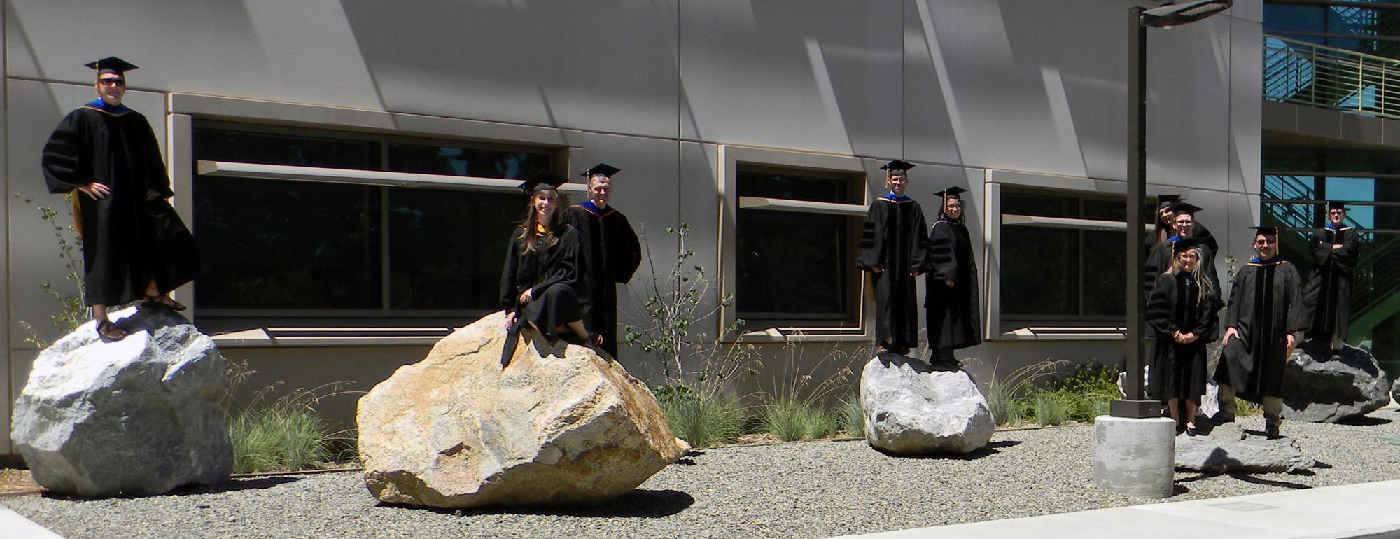 Grad students standing on rocks