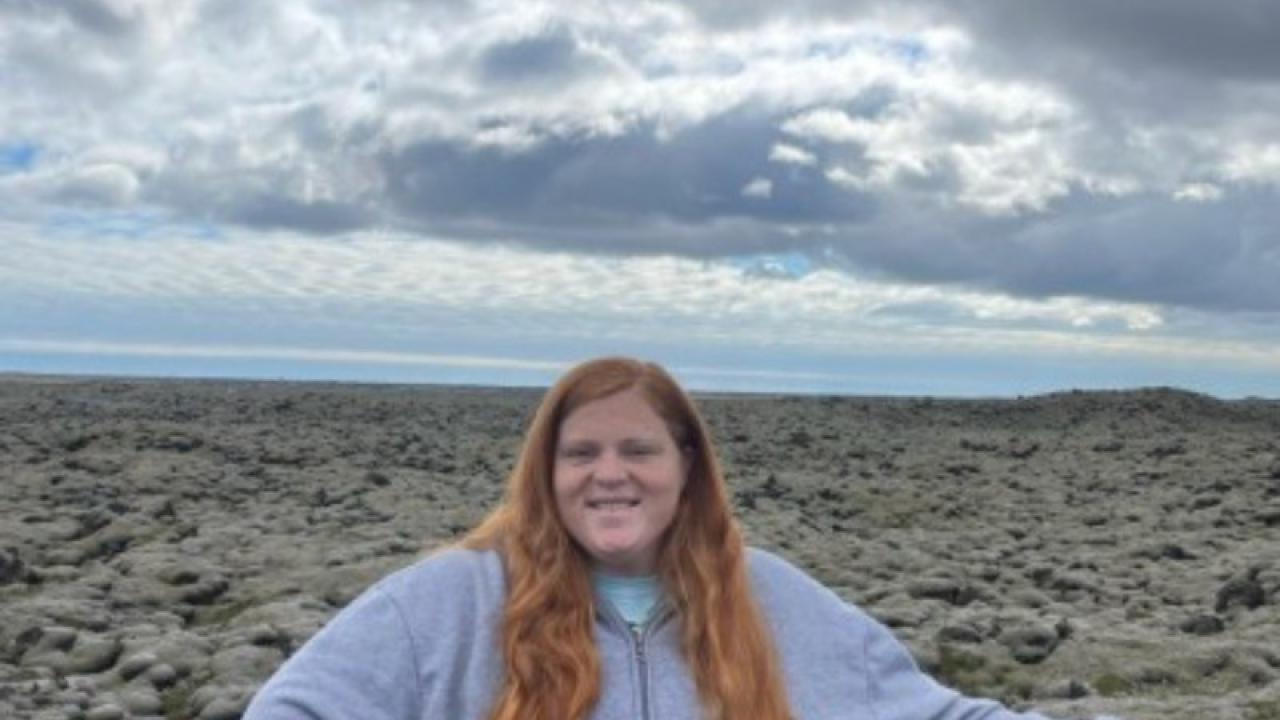 Mikayla Deigan stands in front of an open landscape