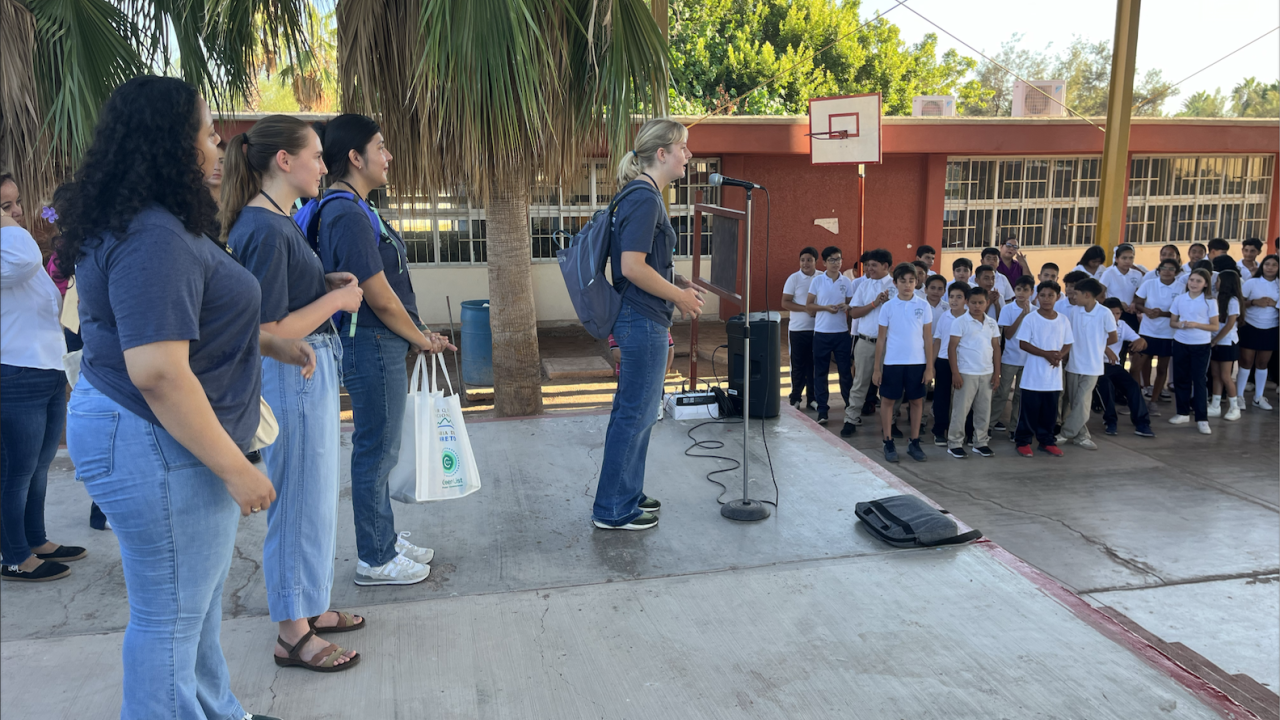 Interns speaking to a group of children