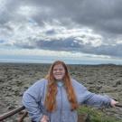 Mikayla Deigan stands in front of an open landscape