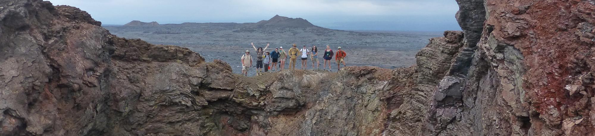 Group of EPS undergraduate students standing on the rim of a crater in Hawaii.